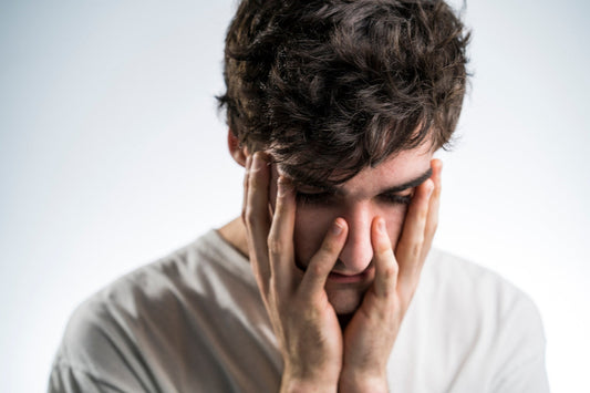 man touching face with both hands